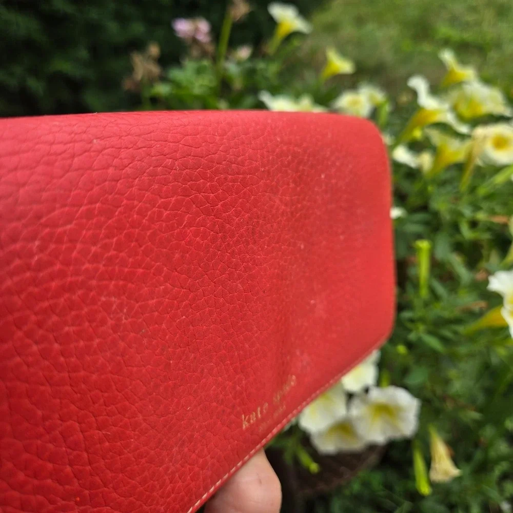 kate spade bifold pebble leather wallet. In red. Flaws